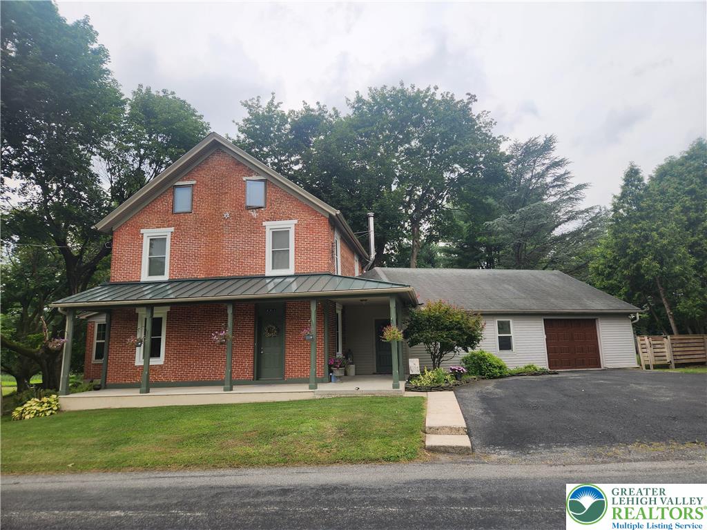 861 Municipal Road Walnutport, PA 18088 - Photo 2 of 94 a front view of a house with a garden
