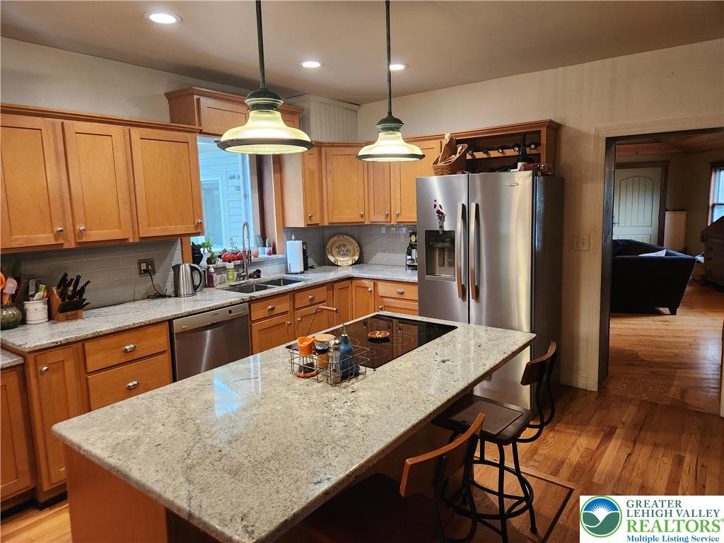 861 Municipal Road Walnutport, PA 18088 - Photo 21 of 94 a kitchen with kitchen island granite countertop a sink a counter top space appliances and cabinets
