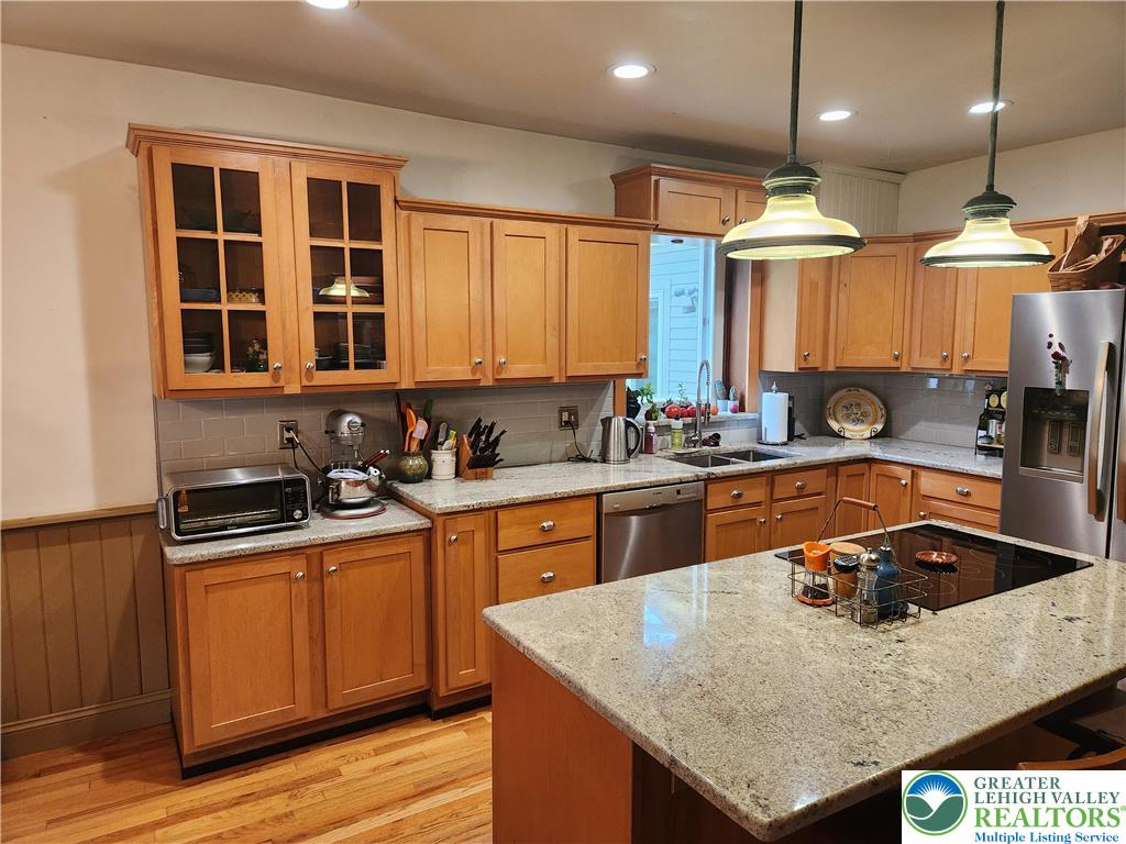 861 Municipal Road Walnutport, PA 18088 - Photo 22 of 94 a kitchen with stainless steel appliances granite countertop a sink a stove and a refrigerator