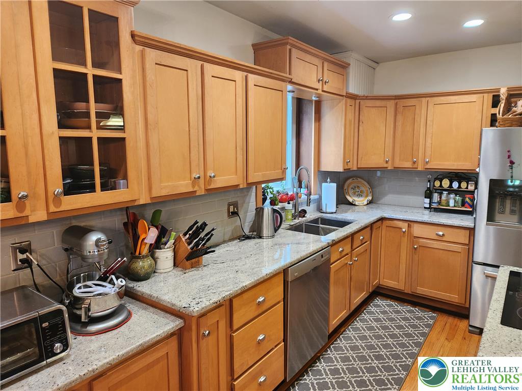 861 Municipal Road Walnutport, PA 18088 - Photo 24 of 94 a kitchen with stainless steel appliances granite countertop a sink stove and cabinets