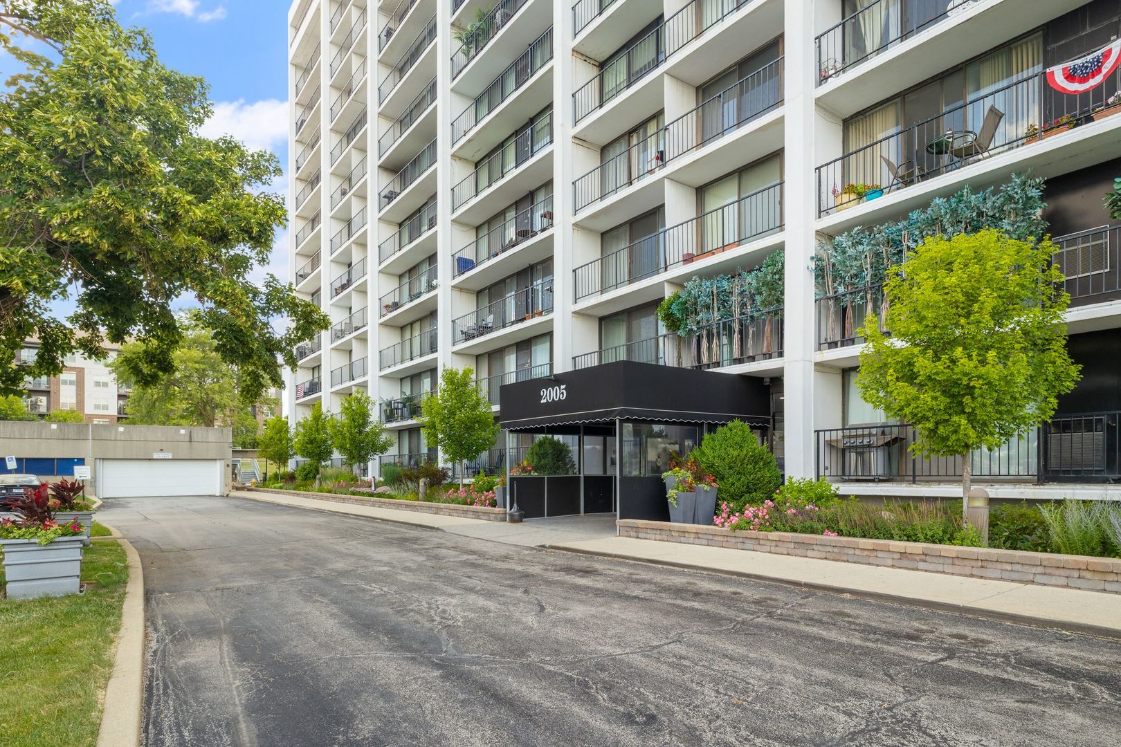 a view of a building with a yard and sitting area