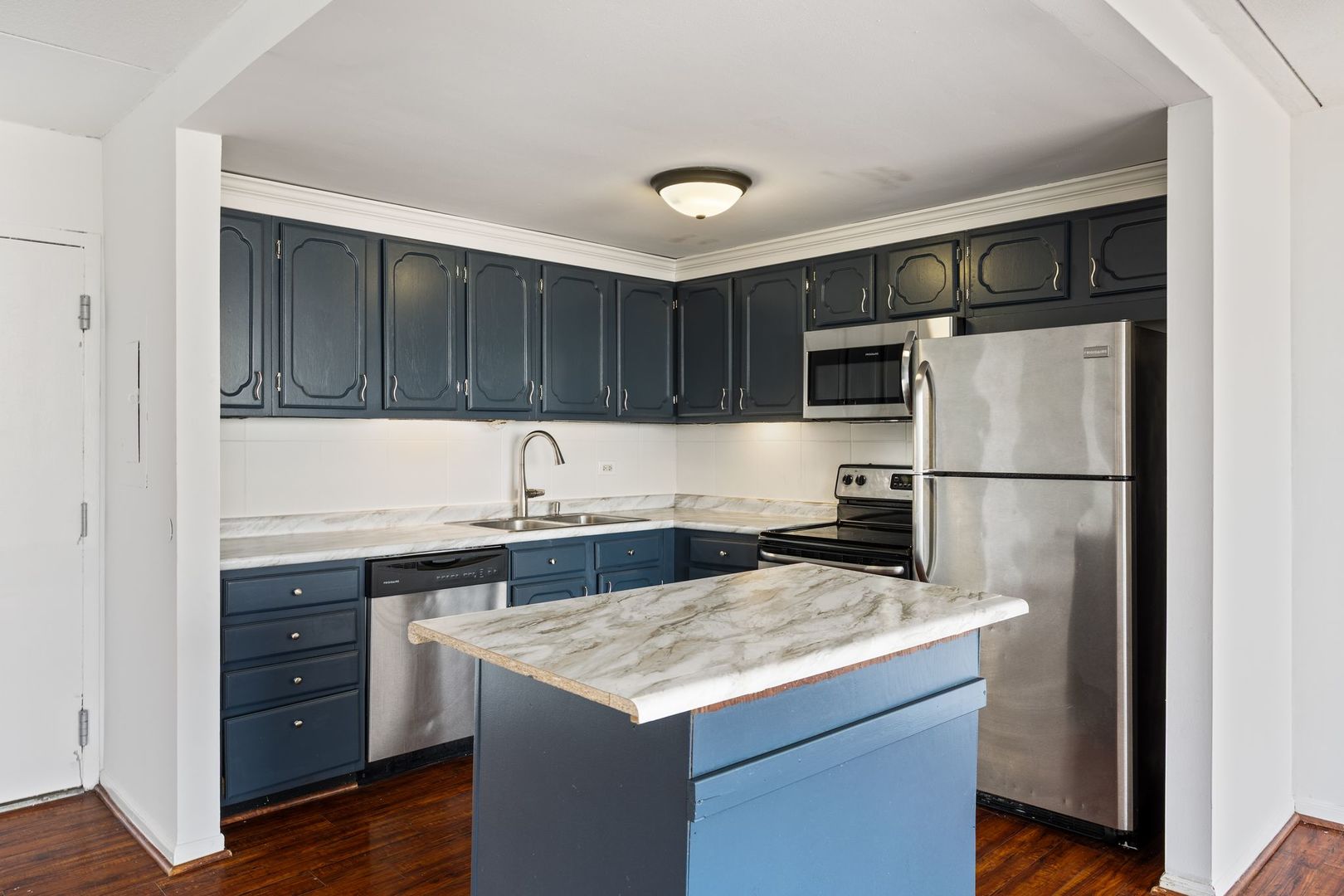 2005 South Finley Road, Unit 1204 Lombard, IL 60148 - Photo 12 of 35 a kitchen with granite countertop a refrigerator and a stove top oven