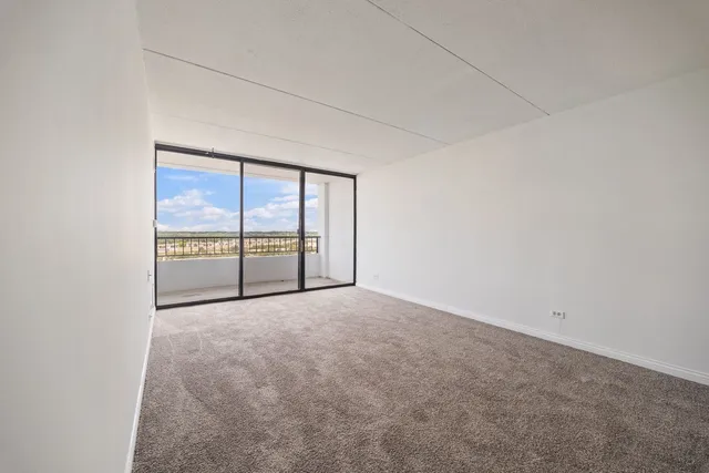 an empty room with large windows