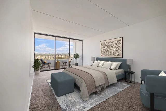 a spacious bedroom with a large bed and a large window