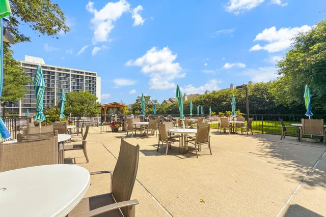 a view of a swimming pool with outdoor seating