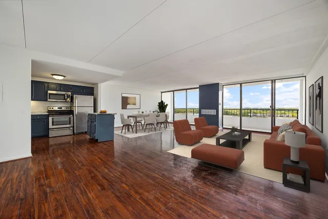 a living room with fireplace furniture and floor to ceiling windows
