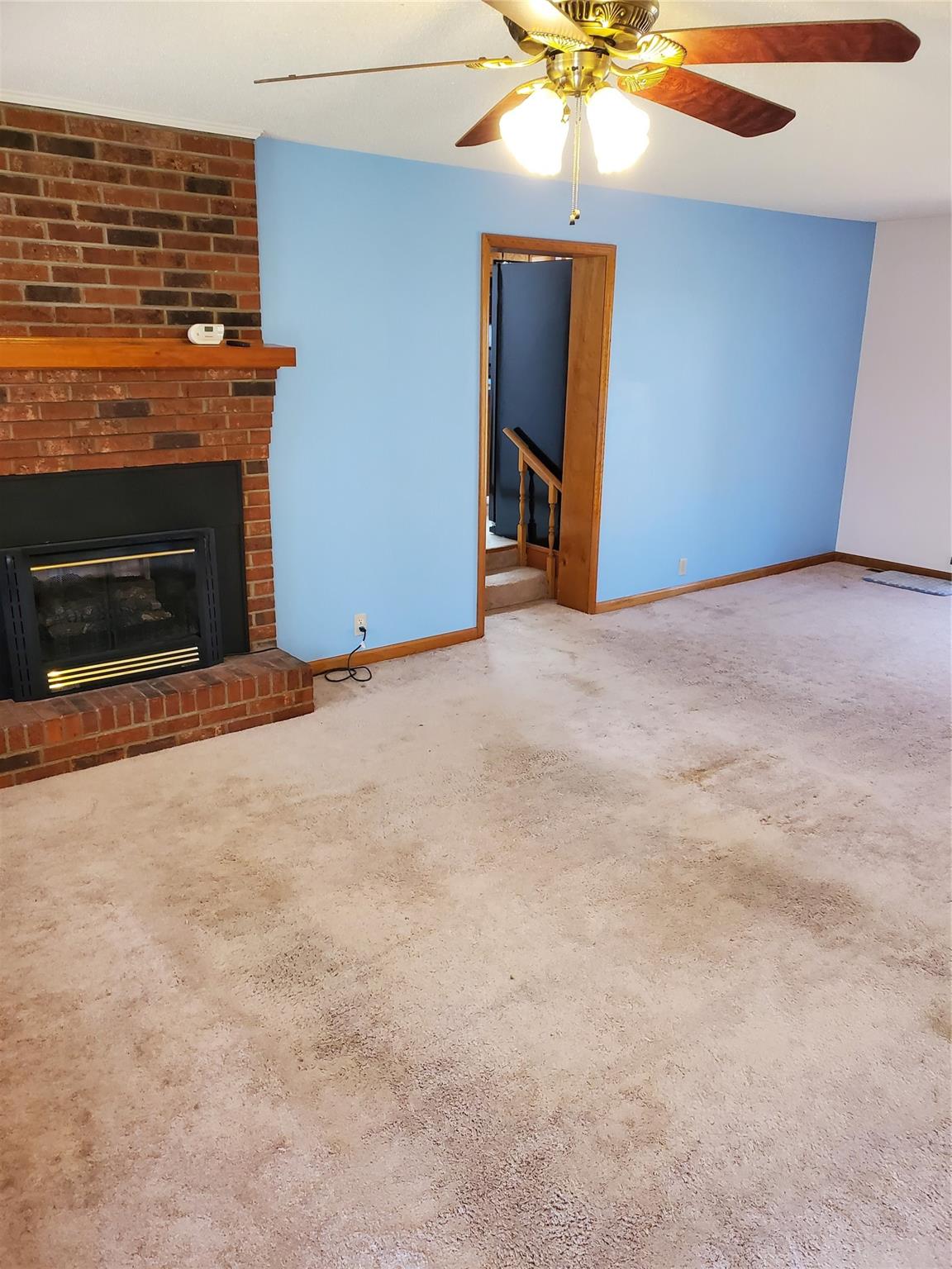 73 Lofty Pine Lane Mills River, NC 28759 - Photo 10 of 29 an empty room with fan and fireplace
