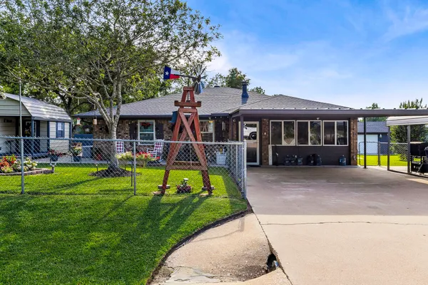 a view of a house with a yard patio and a small yard