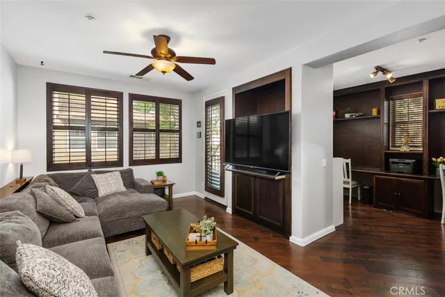 a living room with furniture a ceiling fan and a window