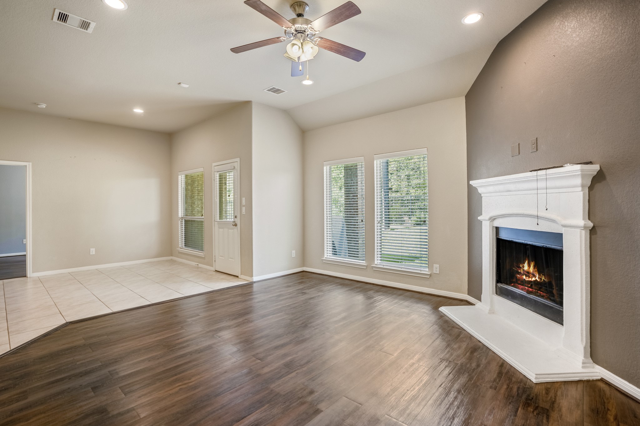 5319 Claymore Meadow Lane Spring, TX 77389 - Photo 10 of 34 a view of an empty room with wooden floor fireplace and a window
