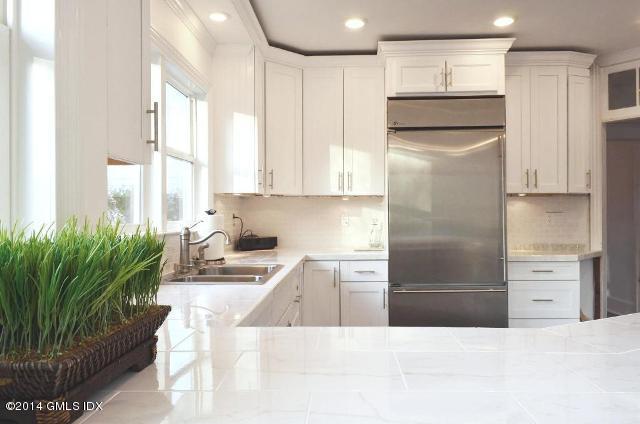 17 Strickland Road Cos Cob, CT 06807 - Photo 14 of 18 a kitchen with stainless steel appliances kitchen island granite countertop a refrigerator and a sink