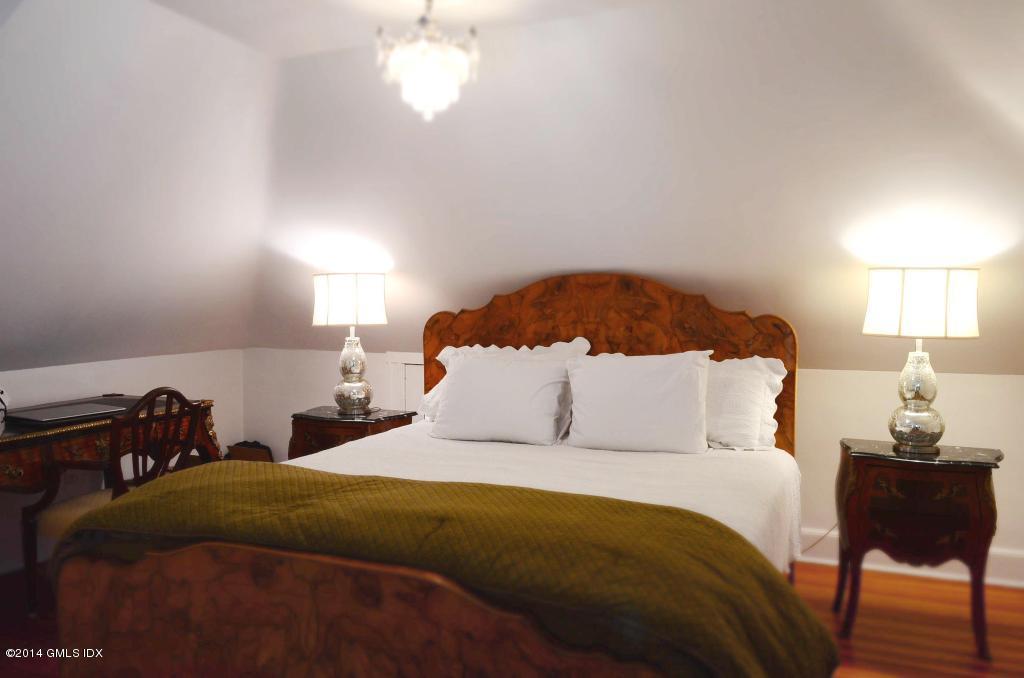 17 Strickland Road Cos Cob, CT 06807 - Photo 15 of 18 a bedroom with a bed and a lamp