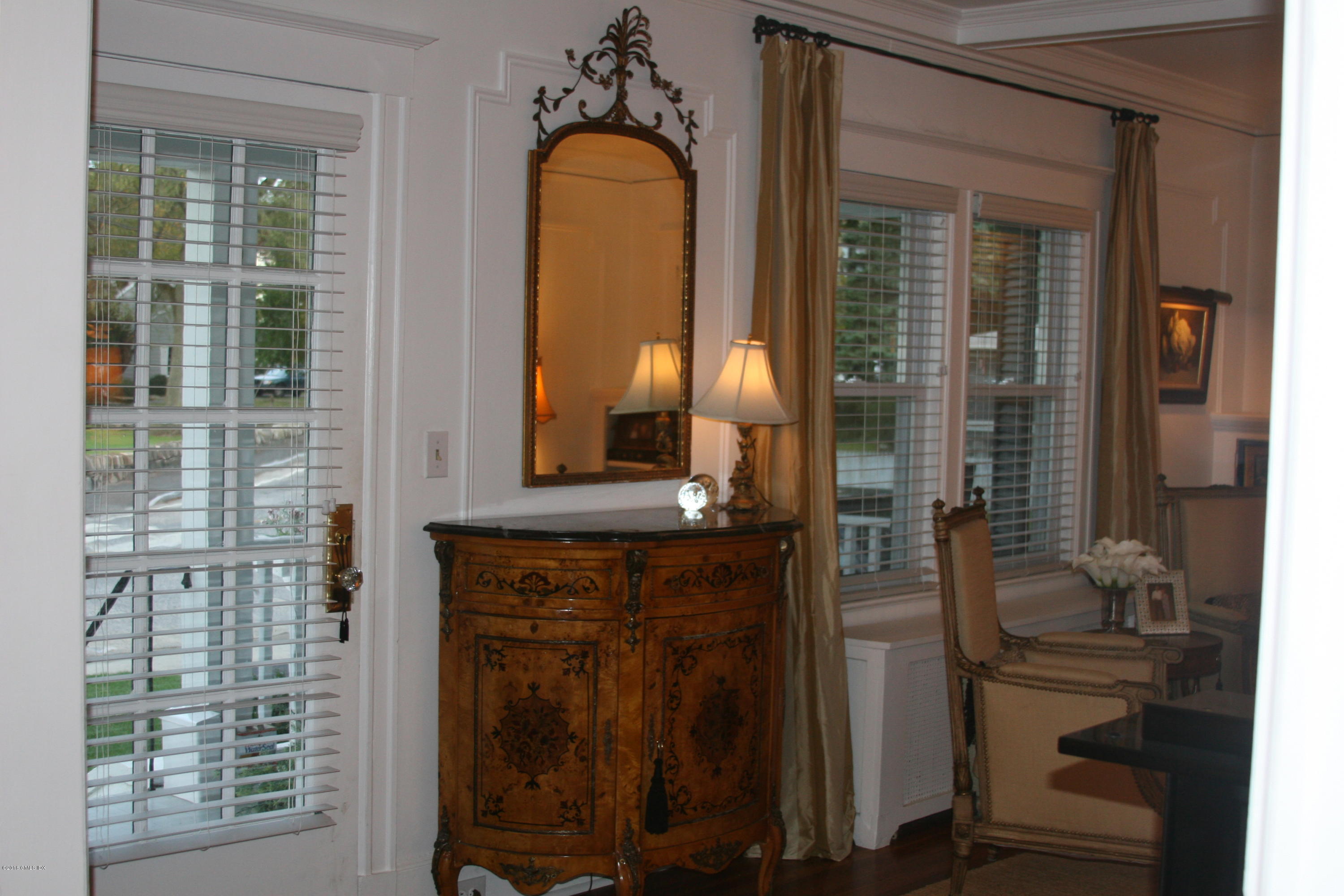 17 Strickland Road Cos Cob, CT 06807 - Photo 5 of 18 a bathroom with a granite countertop sink a mirror and shower view