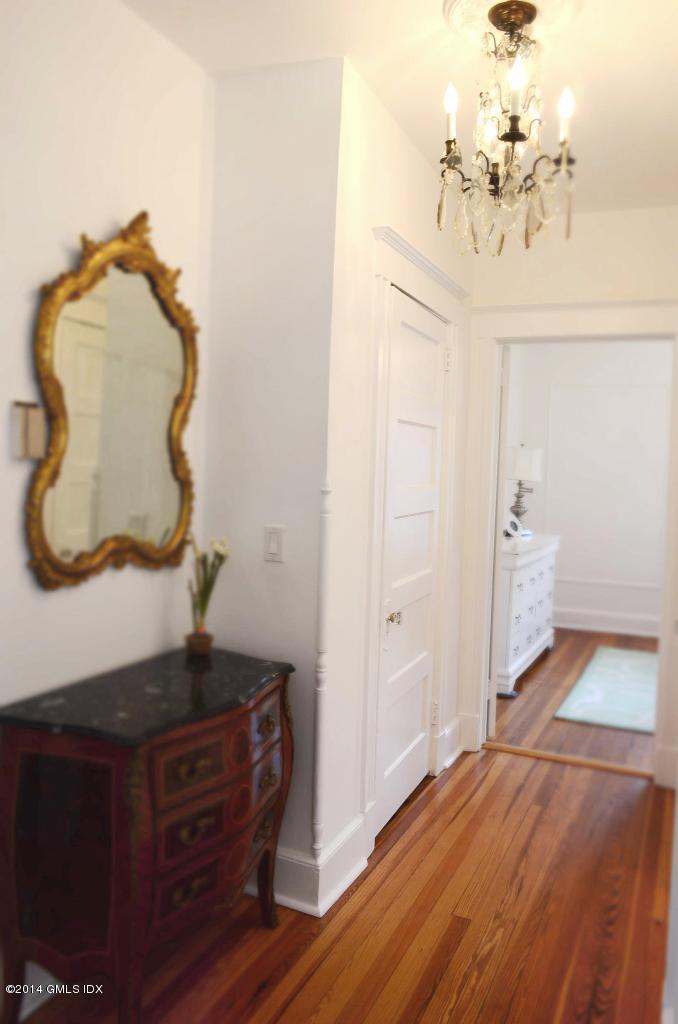17 Strickland Road Cos Cob, CT 06807 - Photo 9 of 18 a view of a hallway with wooden floor and cabinet