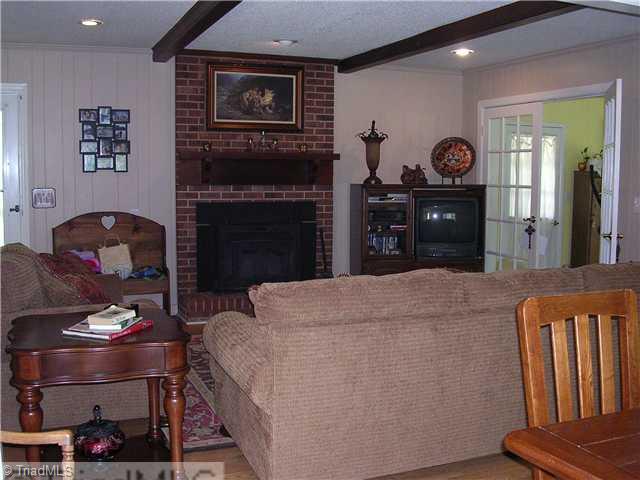 6337 Phillippi Road Julian, NC 27283 - Photo 3 of 16 Living Room. Woodburning stove insert, french doors to bonus/office
