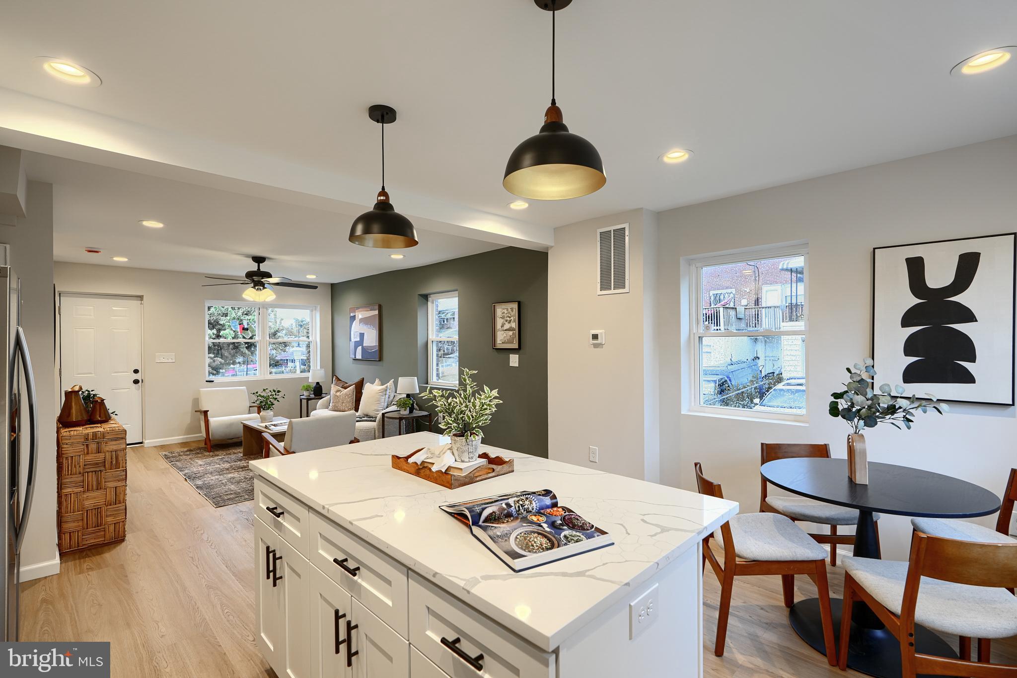 3934 Rokeby Road Baltimore, MD 21229 - Photo 13 of 38 a living room with furniture a dining table and a chandelier