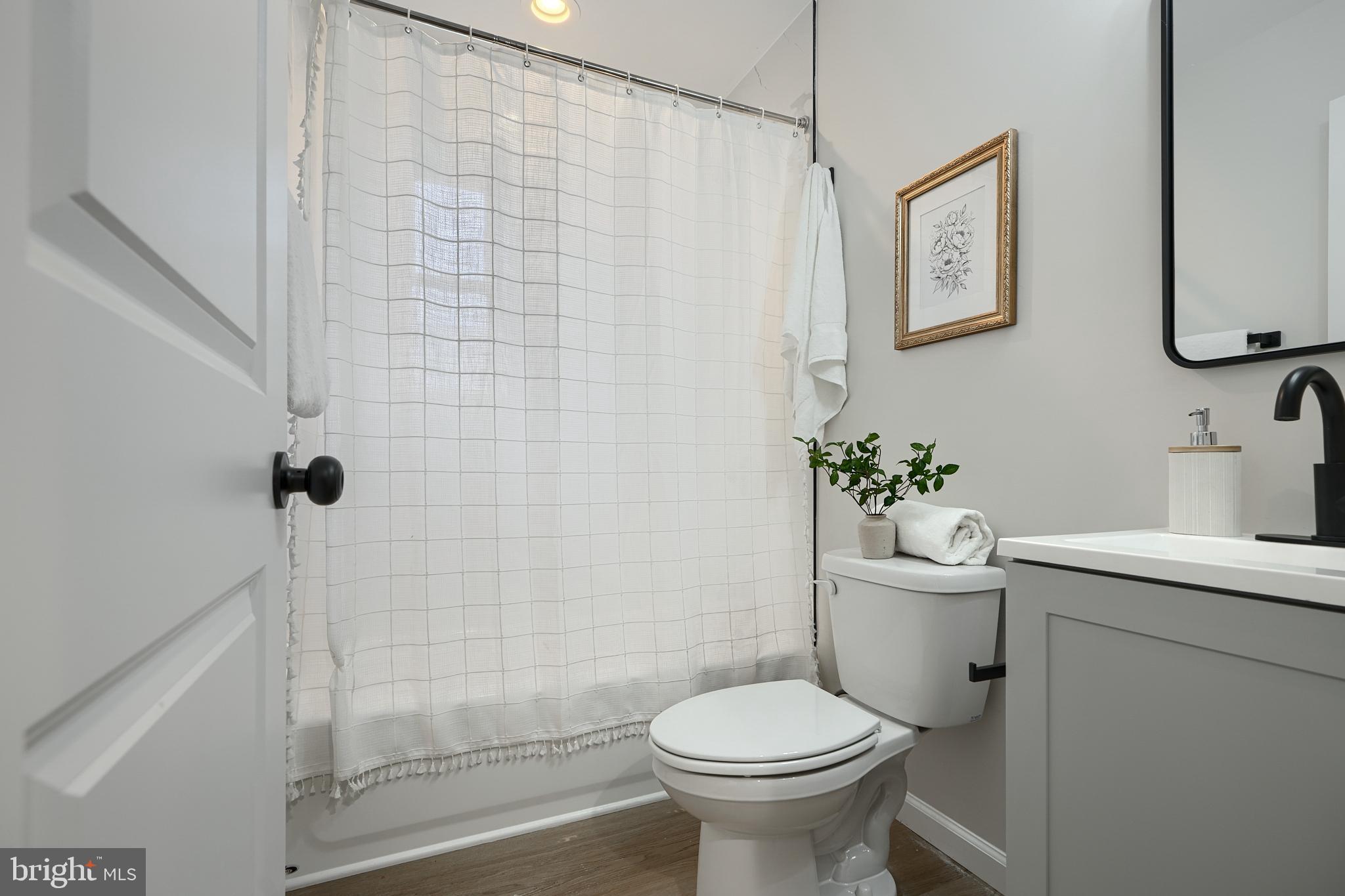 3934 Rokeby Road Baltimore, MD 21229 - Photo 24 of 38 a bathroom with a sink toilet and shower