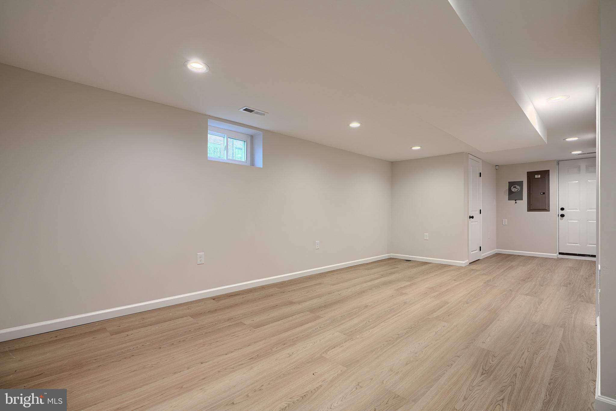 3934 Rokeby Road Baltimore, MD 21229 - Photo 26 of 38 an empty room with wooden floor and windows