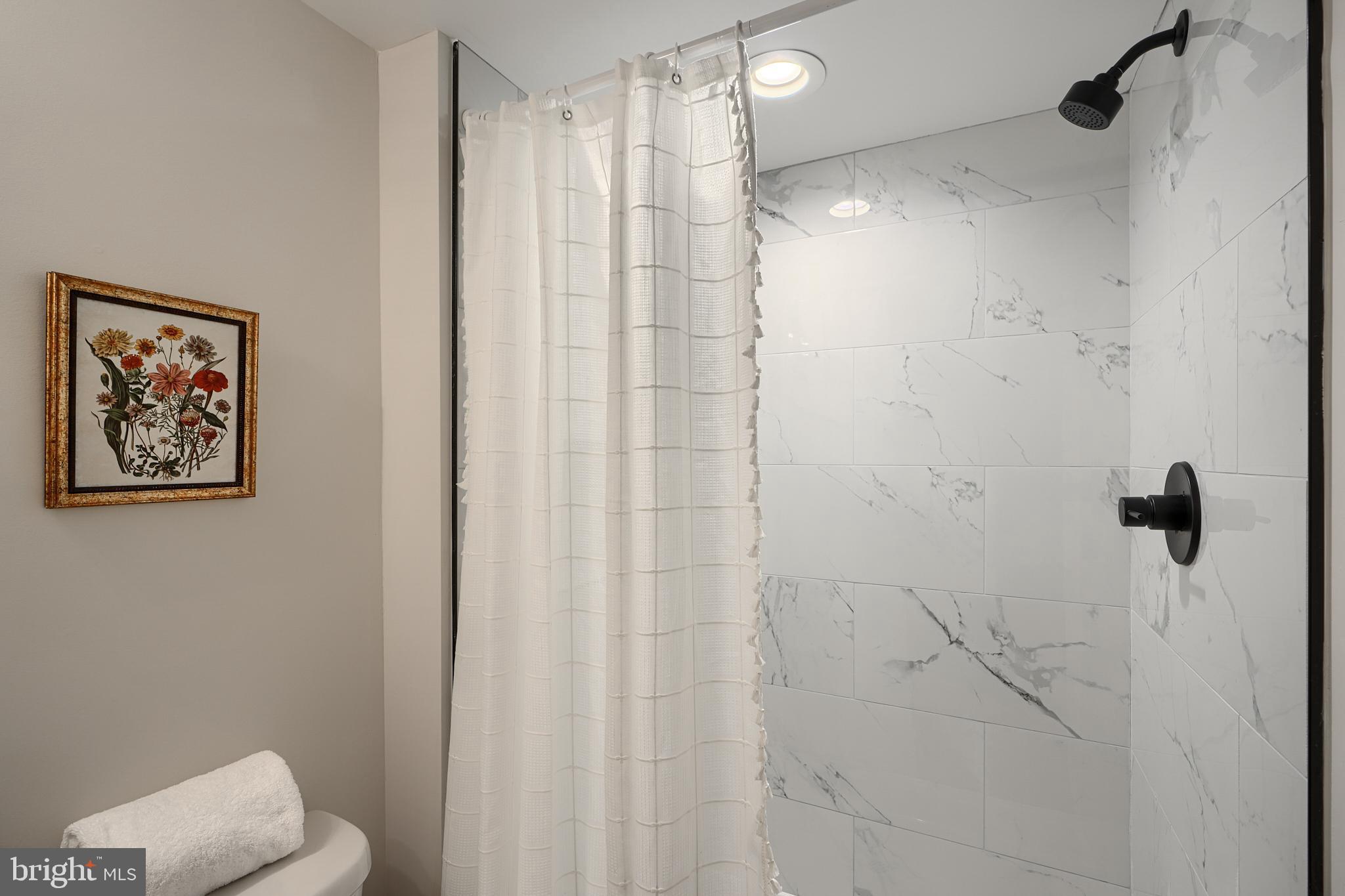 3934 Rokeby Road Baltimore, MD 21229 - Photo 32 of 38 a bathroom with a shower and a toilet