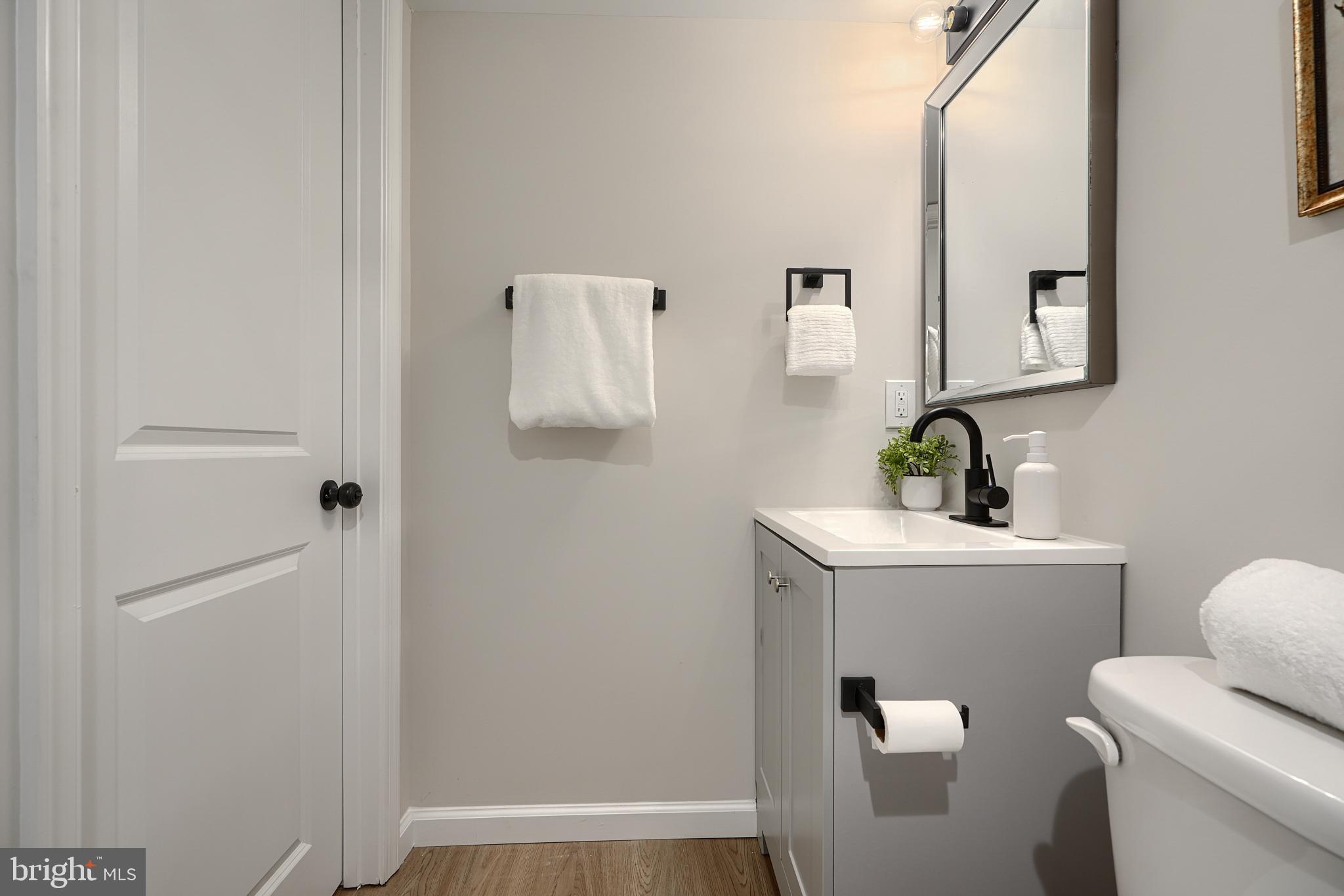 3934 Rokeby Road Baltimore, MD 21229 - Photo 33 of 38 a bathroom with a sink a toilet and mirror