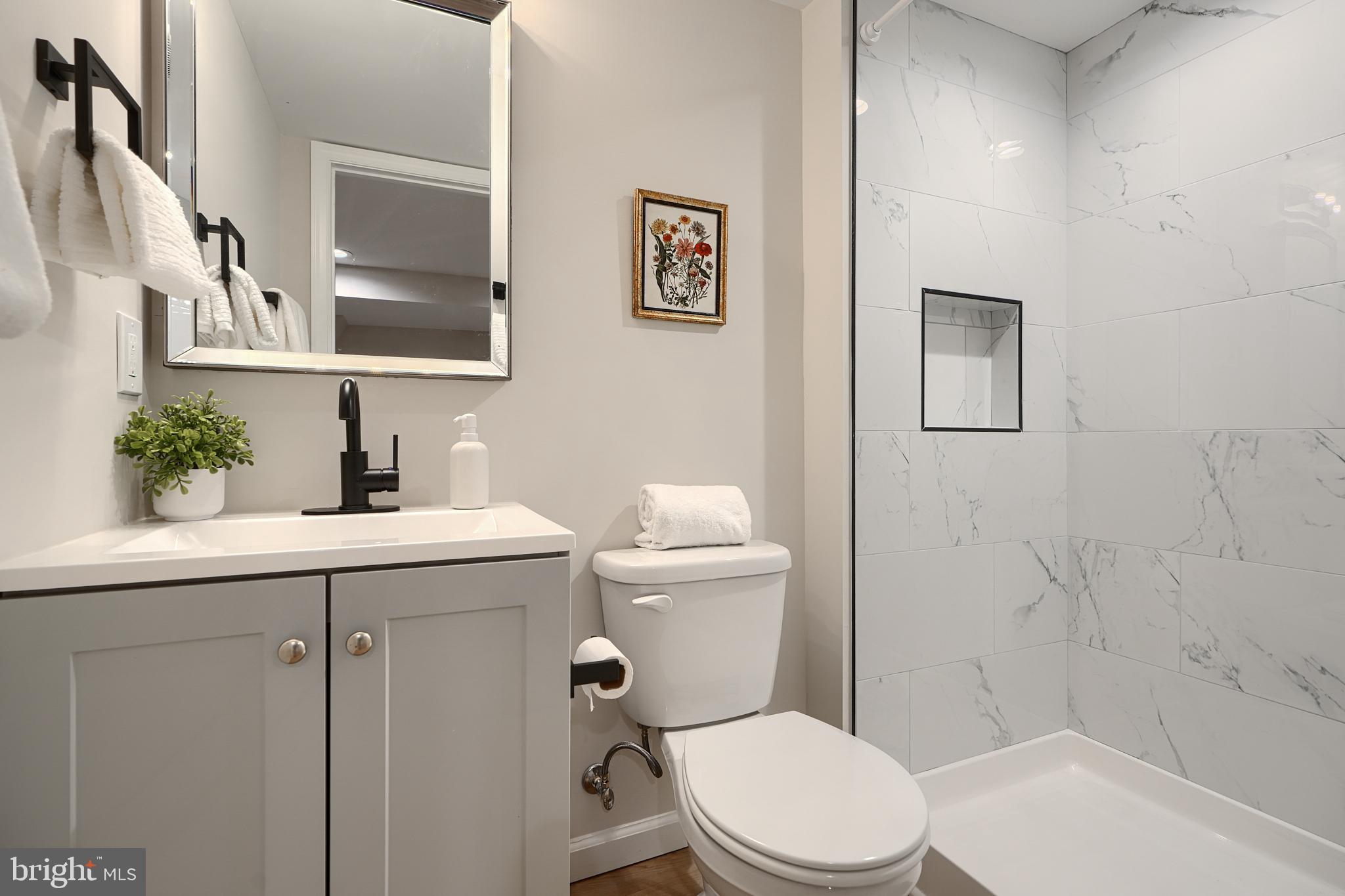 3934 Rokeby Road Baltimore, MD 21229 - Photo 34 of 38 a bathroom with a sink a toilet and shower