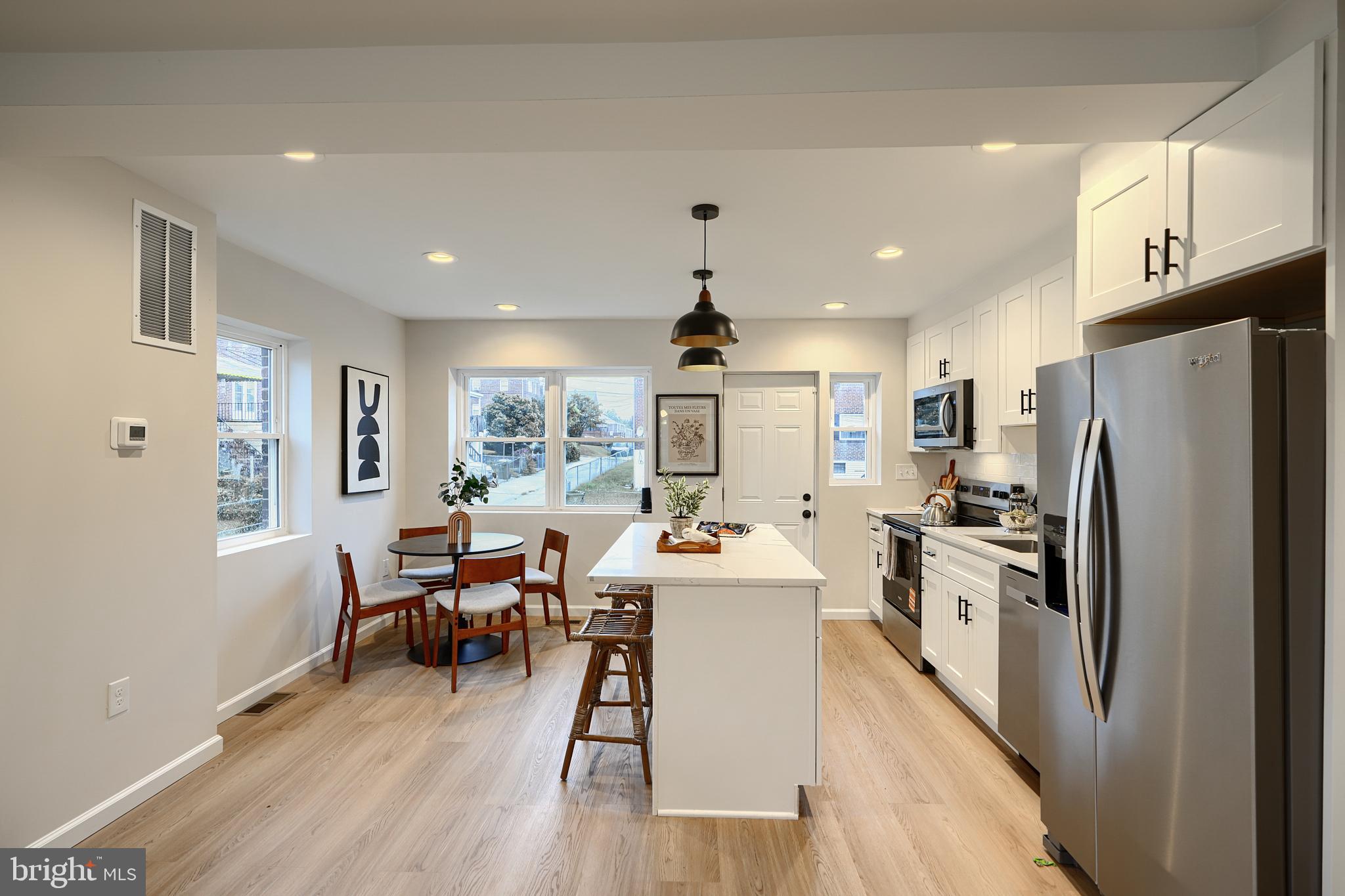 3934 Rokeby Road Baltimore, MD 21229 - Photo 8 of 38 a room with stainless steel appliances a dining table wooden floor and a window