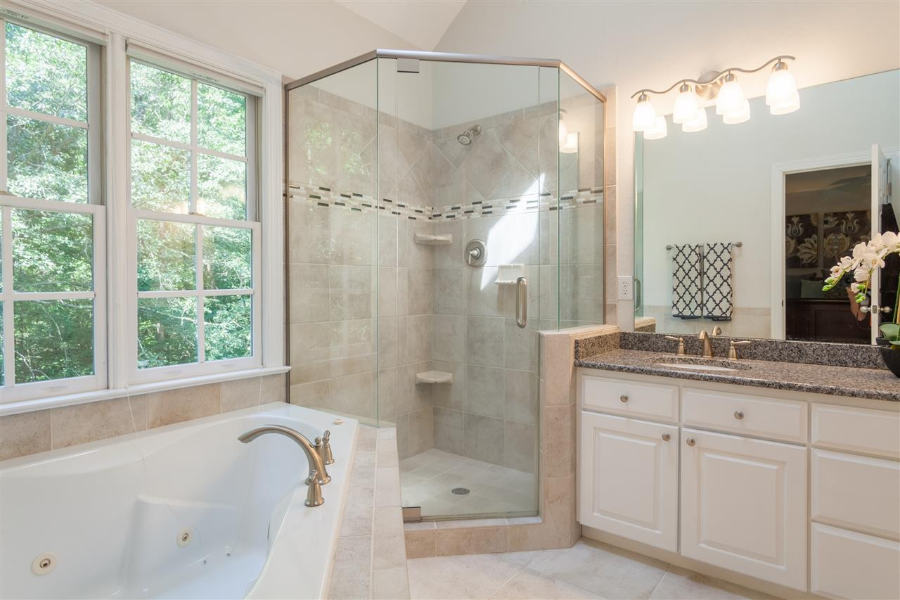 4124 Ridgebrook Bluffs Drive Raleigh, NC 27603 - Photo 12 of 24 Updated bath with jetted tub, frameless shower and designer tile. Master Bath/Spa