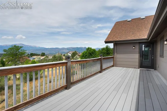 a balcony with wooden floor and fence