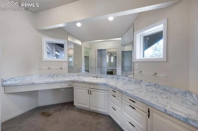 a spacious bathroom with a granite countertop sink mirror and