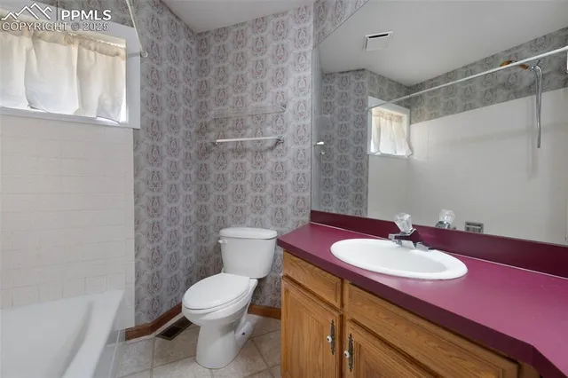 a bathroom with a sink toilet a mirror and shower