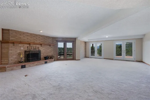 a view of a livingroom with an empty space and a fireplace
