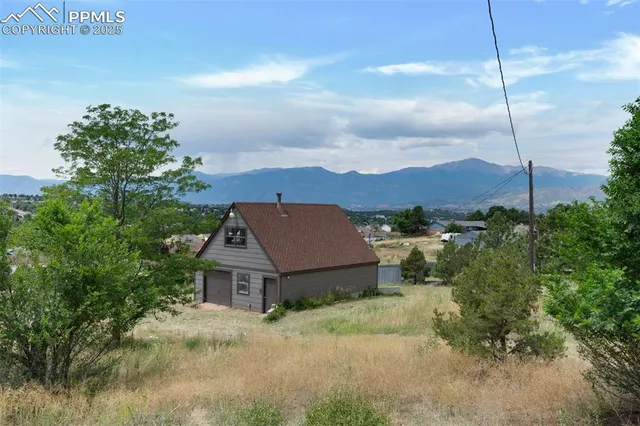 a view of house with a big yard and a fountain