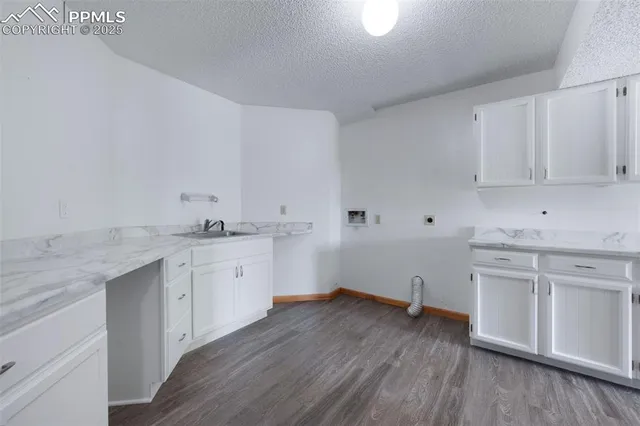 a view of a kitchen with granite countertop white cabinets and white appliances