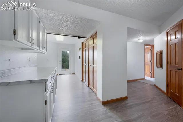 a view of a hallway with wooden floor