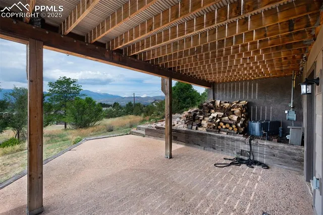 a view of a porch with furniture and floor to ceiling window