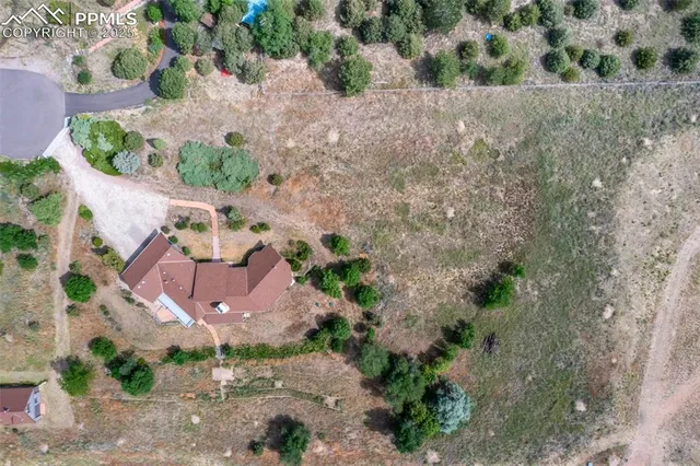an aerial view of a house with a yard