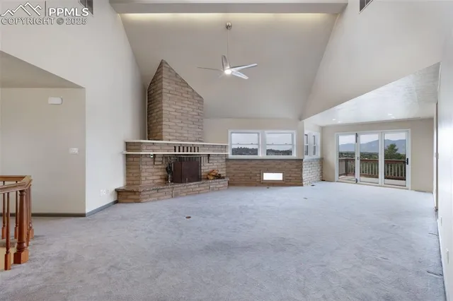 an empty room with furniture and a fireplace