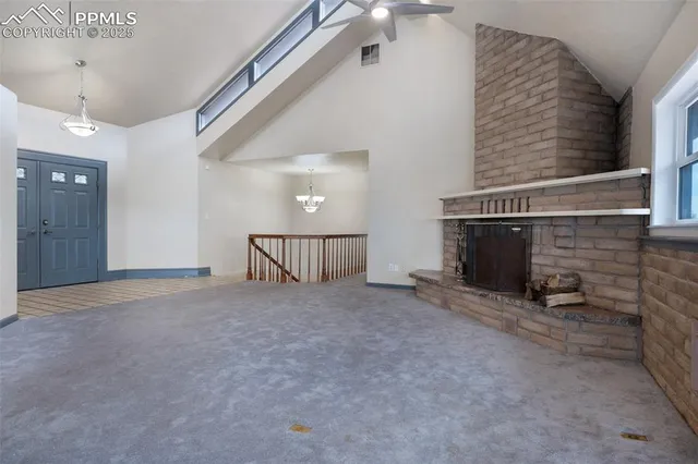 a view of an empty room with a fireplace