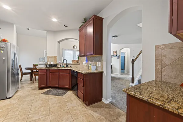 a kitchen with stainless steel appliances granite countertop a sink and cabinets