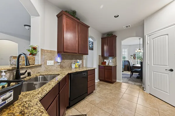 a kitchen with a sink refrigerator and cabinets