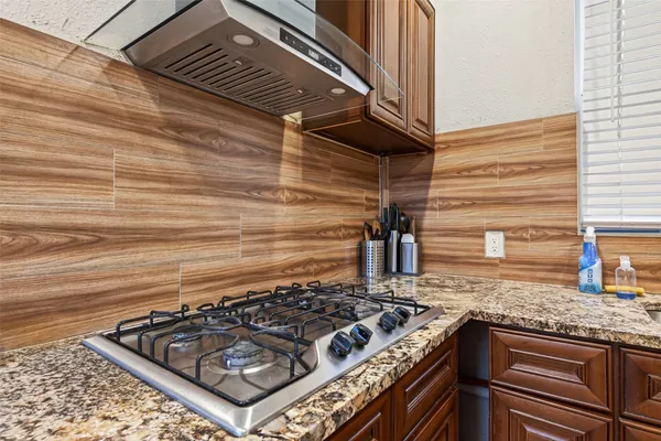 a stove top oven sitting inside of a kitchen