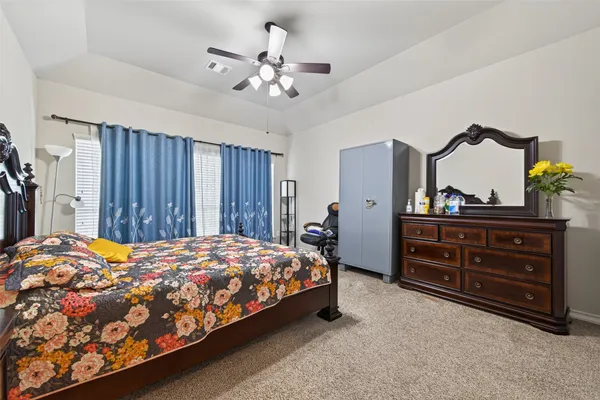 a bedroom with a bed and a dresser