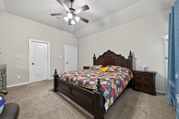 a bedroom with a bed and a chandelier
