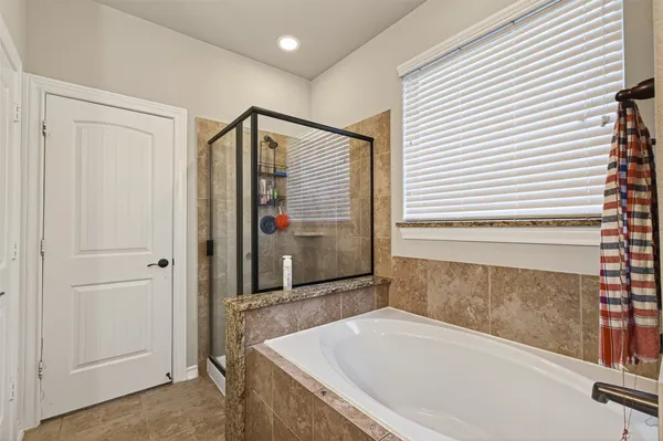 a bathroom with a bathtub and a shower