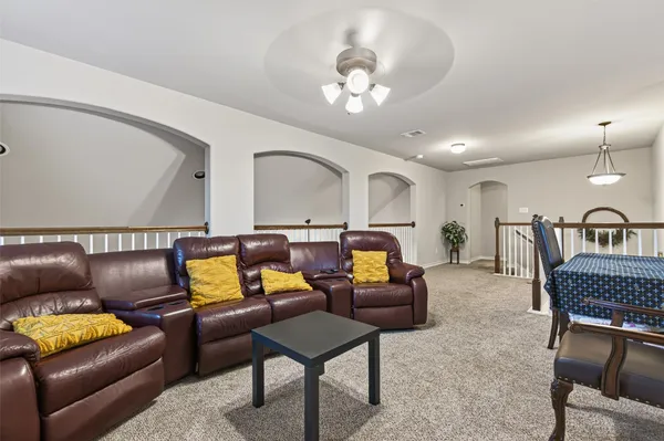a living room with furniture a fireplace and a chandelier