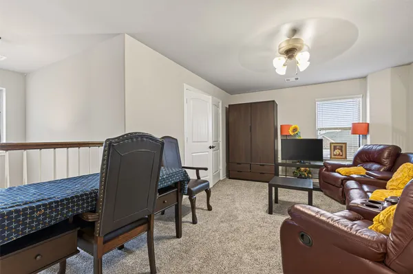 a living room with furniture and a piano