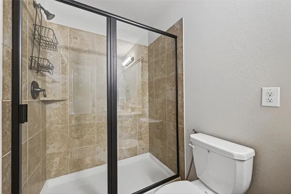 a bathroom with a shower and toilet