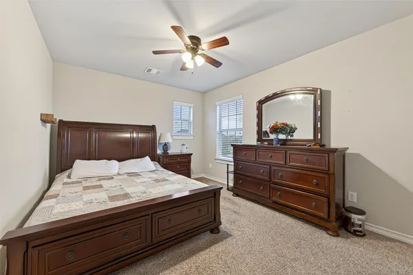 a bedroom with a bed and a dresser