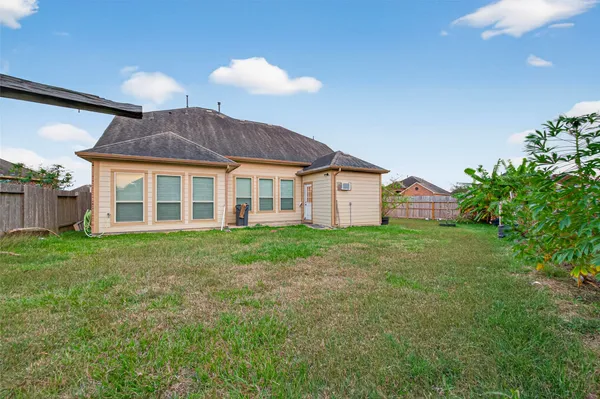 a view of a house with a backyard
