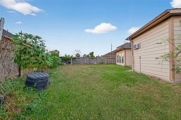 a view of a backyard with plants and a patio
